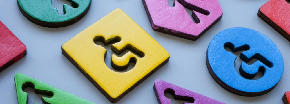 Colorful blocks of different shapes  on a plain background featuring various icons, including wheelchair accessibility and people symbols, representing diversity and inclusion.