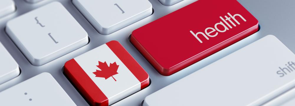 Clavier d'ordinateur blanc et argenté comportant une touche représentant le drapeau canadien et une touche rouge sur laquelle on peut lire "health" (santé) en lettres blanches.