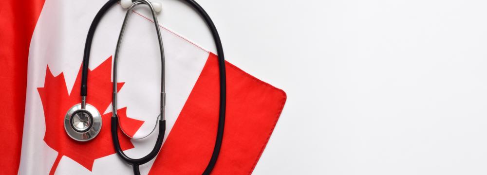A stethoscope placed on a Canadian flag.